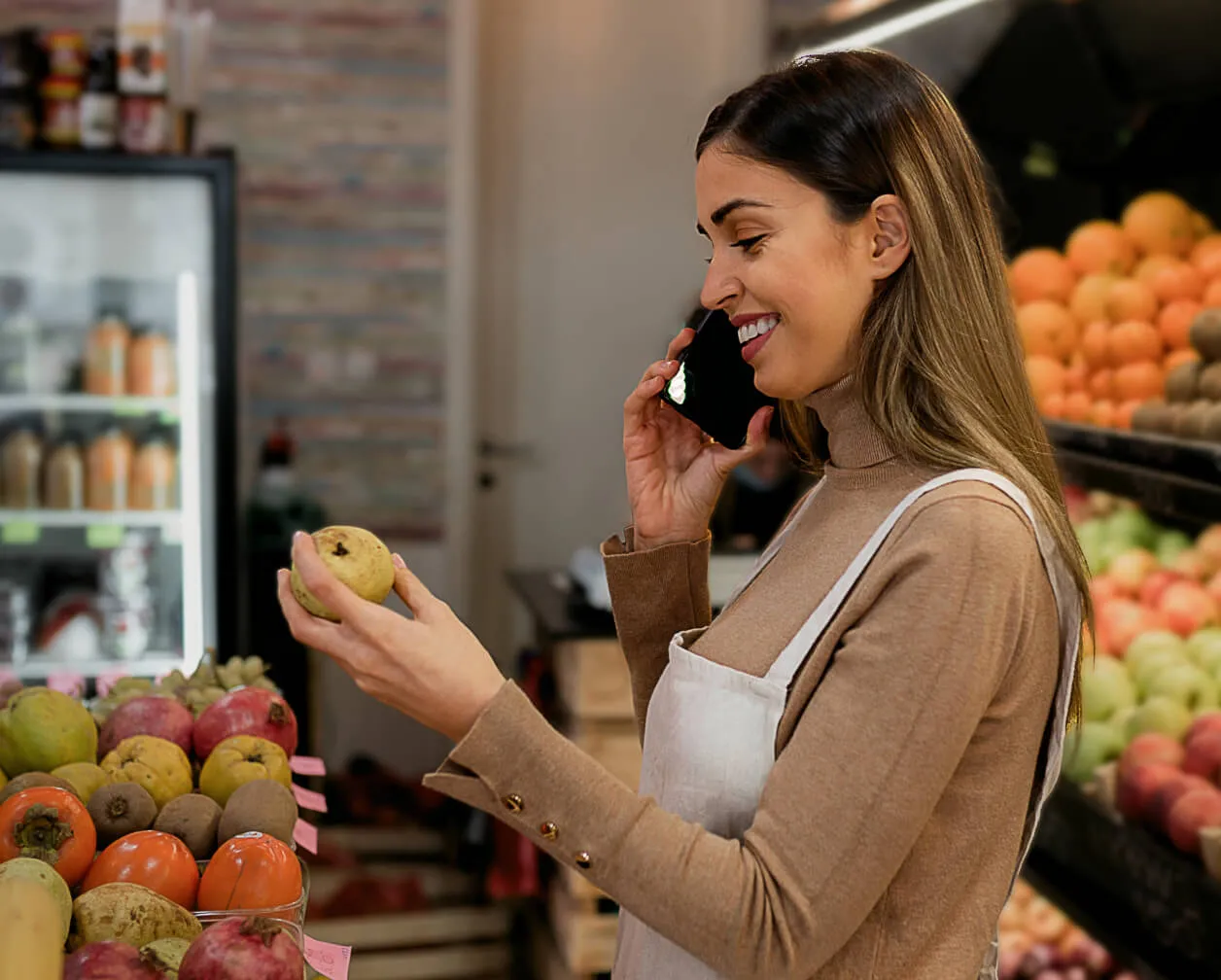 A female retail store employee placing orders from a mobile phone by using RingCentral's integrated business communications solution