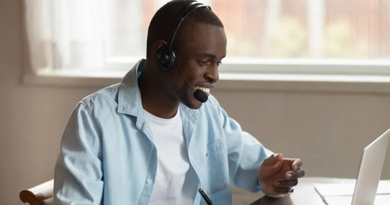 A man using internet phone on his laptop